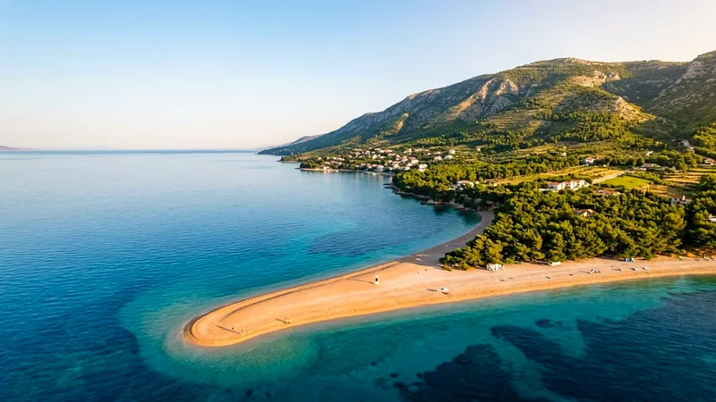 Aerial view of Zlatni Rat pebble beach curving into turquoise sea near Bol.